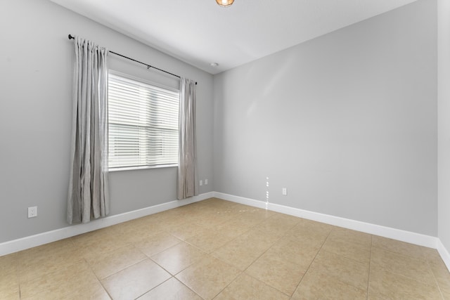 spare room with light tile patterned floors