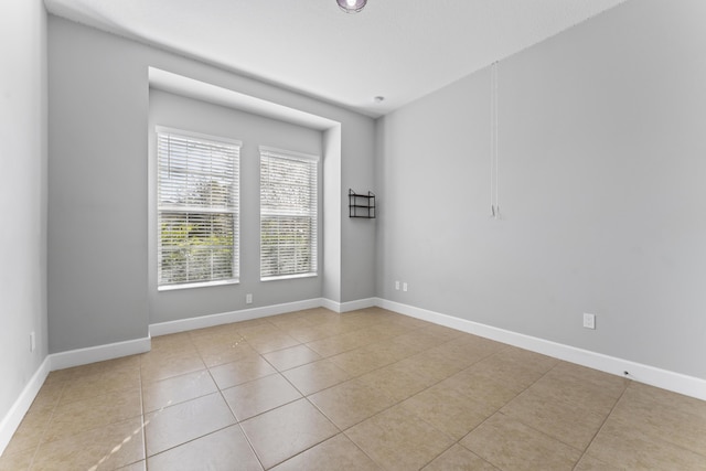 spare room featuring light tile patterned floors