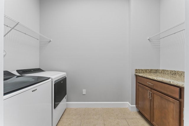 laundry area with light tile patterned flooring and independent washer and dryer