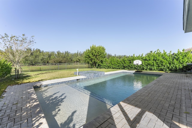 view of swimming pool with a yard and a patio area