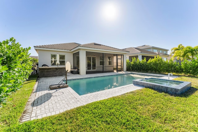 view of swimming pool with a sunroom, a yard, an in ground hot tub, and a patio