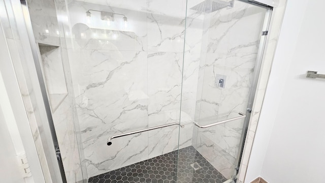 bathroom featuring a shower with door