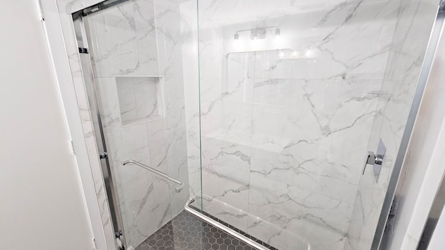 bathroom with a shower with door