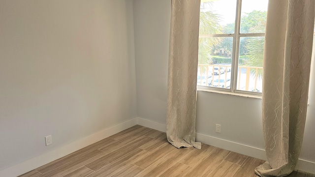 spare room with light wood-type flooring