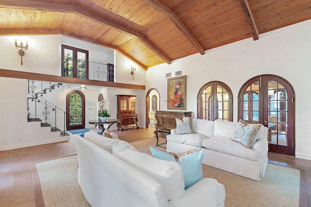 tiled living room featuring beam ceiling, wooden ceiling, high vaulted ceiling, and french doors