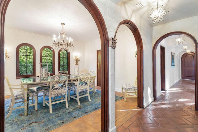 dining room with a notable chandelier and crown molding