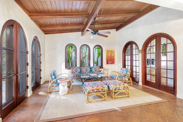 living room with french doors, lofted ceiling with beams, ceiling fan, and wood ceiling