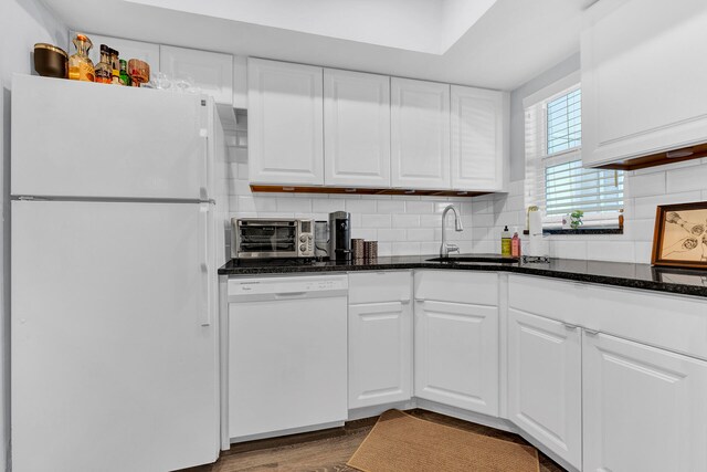 kitchen featuring white cabinetry, sink, dark wood-type flooring, white appliances, and decorative backsplash