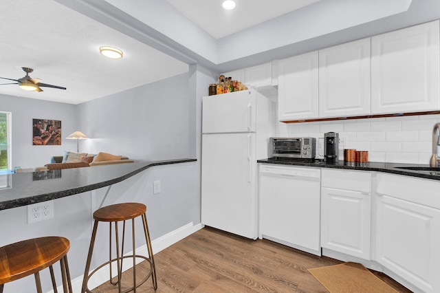 kitchen featuring ceiling fan, light hardwood / wood-style flooring, white cabinets, and white appliances