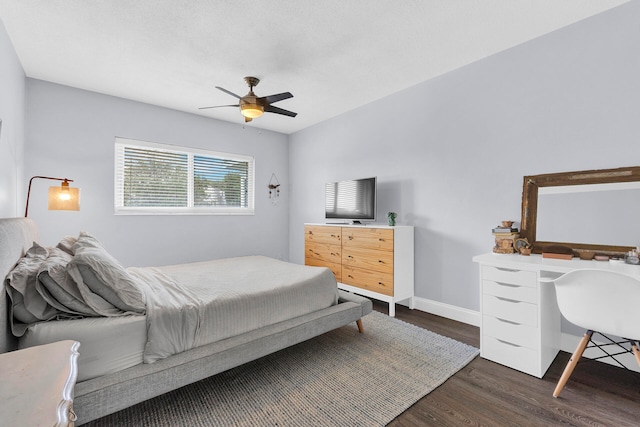 bedroom with ceiling fan and dark wood-type flooring