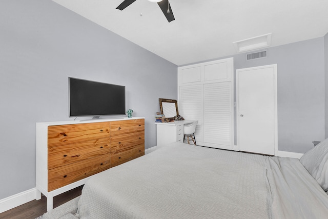 bedroom with a closet, vaulted ceiling, ceiling fan, and dark hardwood / wood-style floors