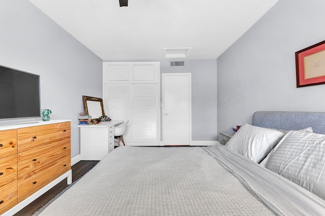 bedroom with dark hardwood / wood-style flooring and ceiling fan