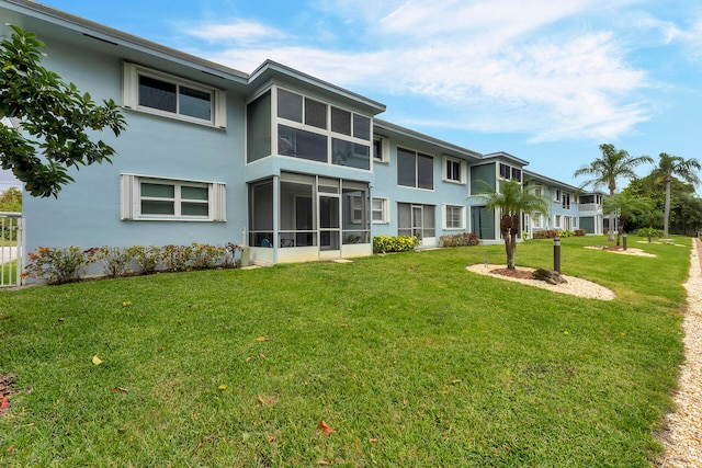 back of property featuring a lawn