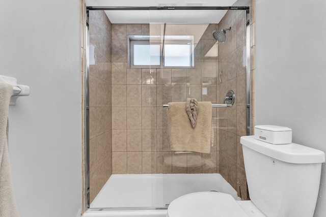 bathroom with walk in shower and toilet