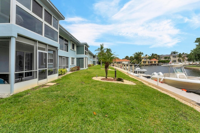 view of yard featuring a water view and a boat dock