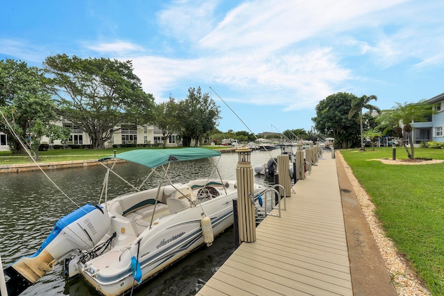 view of dock featuring a water view and a yard