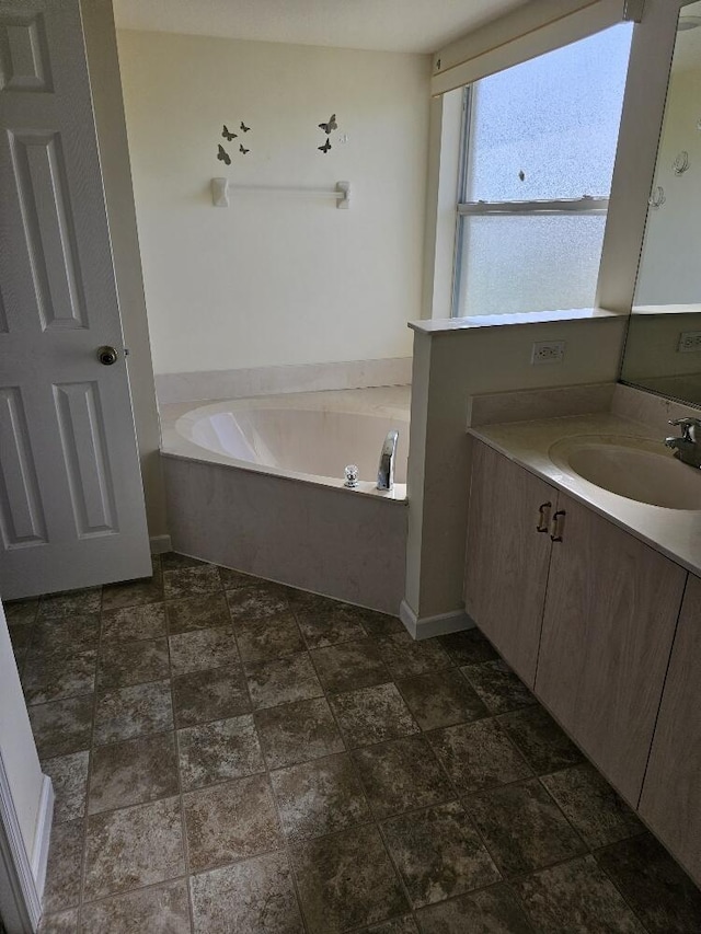 bathroom featuring vanity and a tub to relax in