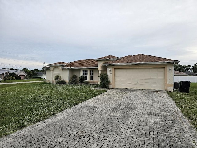 view of front of home with a front yard and a garage