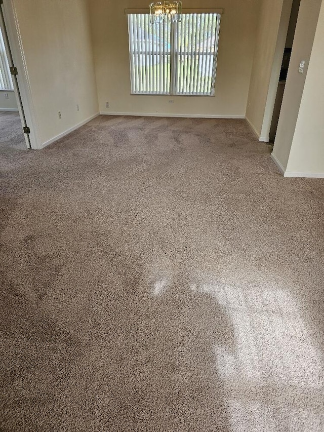 empty room featuring a chandelier