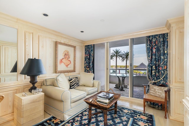 living room with ornamental molding and light hardwood / wood-style floors