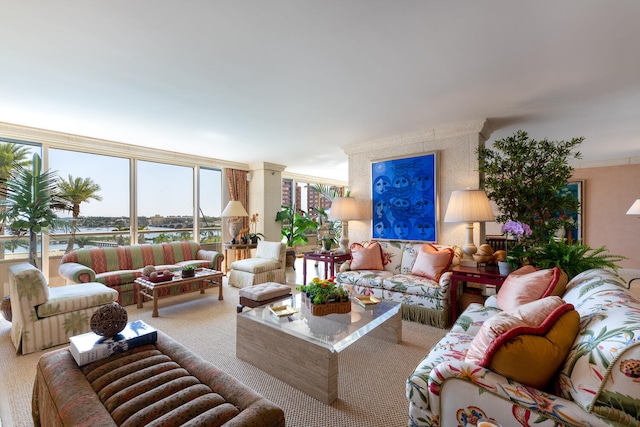 living room featuring ornate columns and carpet