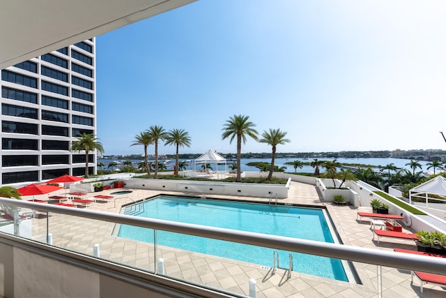 view of swimming pool with a water view