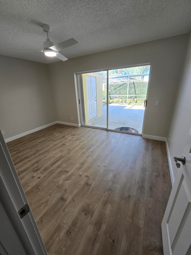 unfurnished room featuring wood-type flooring, a textured ceiling, and ceiling fan