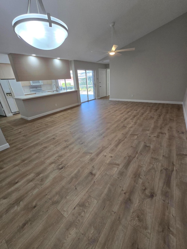 unfurnished living room with hardwood / wood-style flooring, ceiling fan, and lofted ceiling