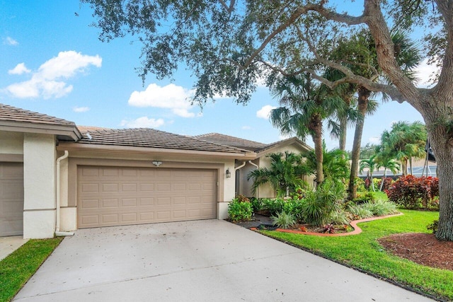 view of front of house with a garage and a front lawn