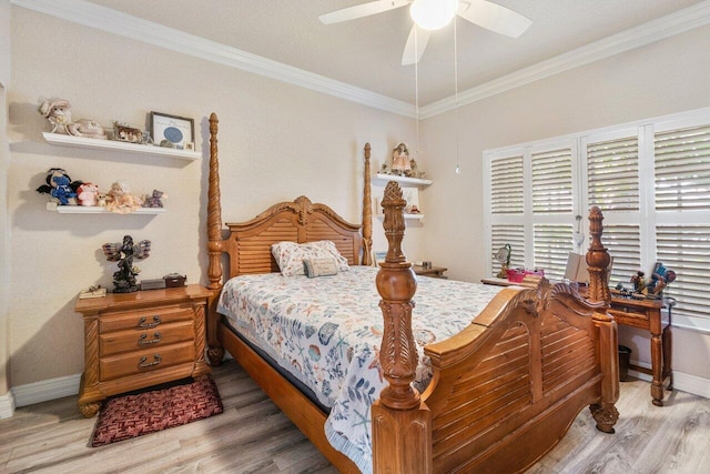 bedroom with crown molding, hardwood / wood-style flooring, and ceiling fan