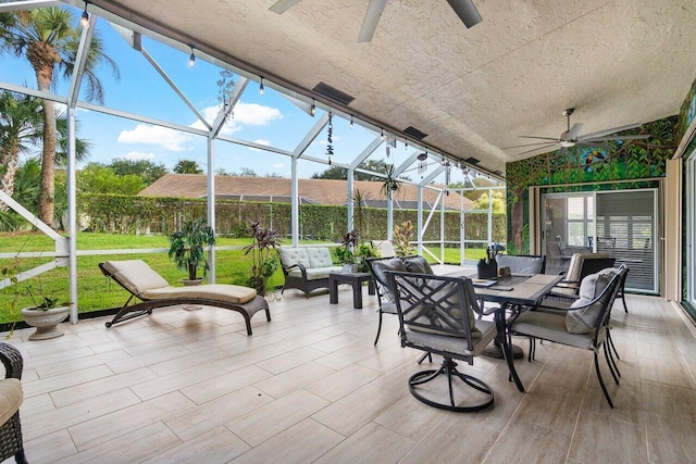 sunroom featuring ceiling fan