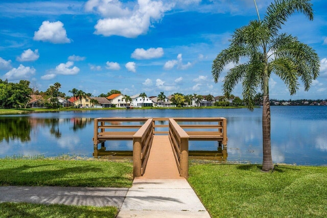 dock area featuring a lawn and a water view