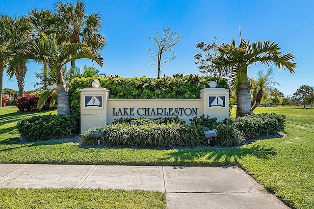 community sign featuring a lawn