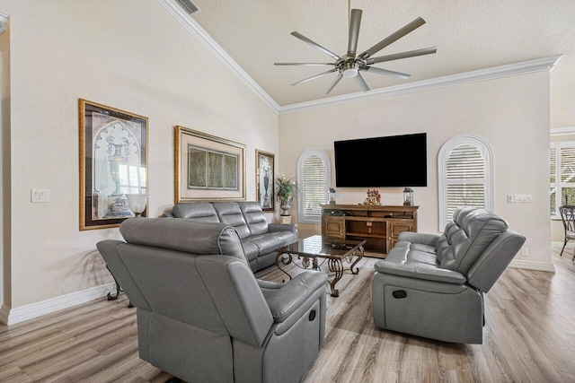 living room featuring ceiling fan, ornamental molding, light hardwood / wood-style flooring, and a textured ceiling