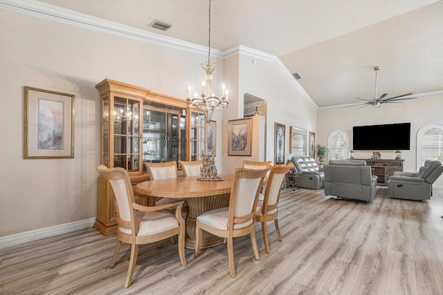 dining area with vaulted ceiling, crown molding, ceiling fan with notable chandelier, and light hardwood / wood-style floors