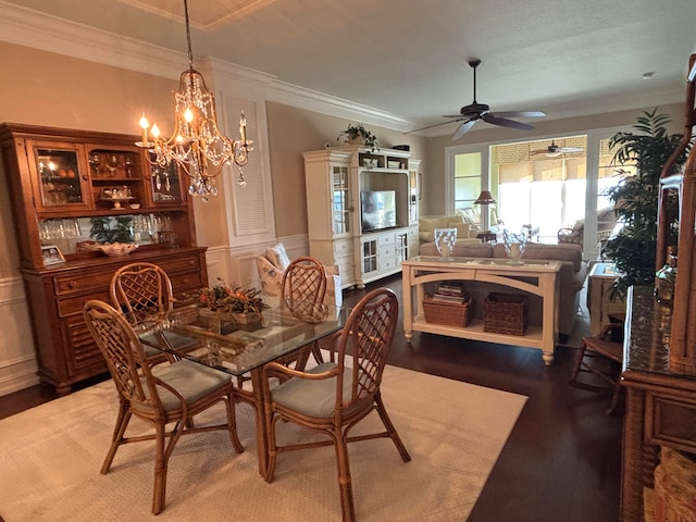 dining area with crown molding, hardwood / wood-style floors, and ceiling fan with notable chandelier