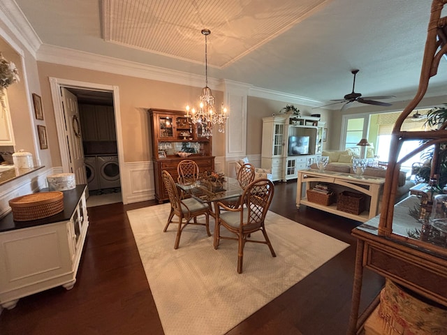 dining room featuring ceiling fan with notable chandelier, dark hardwood / wood-style flooring, separate washer and dryer, and ornamental molding