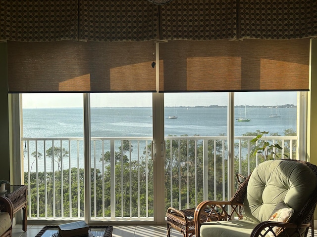 sunroom / solarium featuring a water view and a wealth of natural light