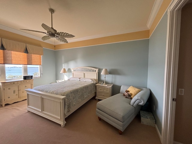 carpeted bedroom with ceiling fan and ornamental molding