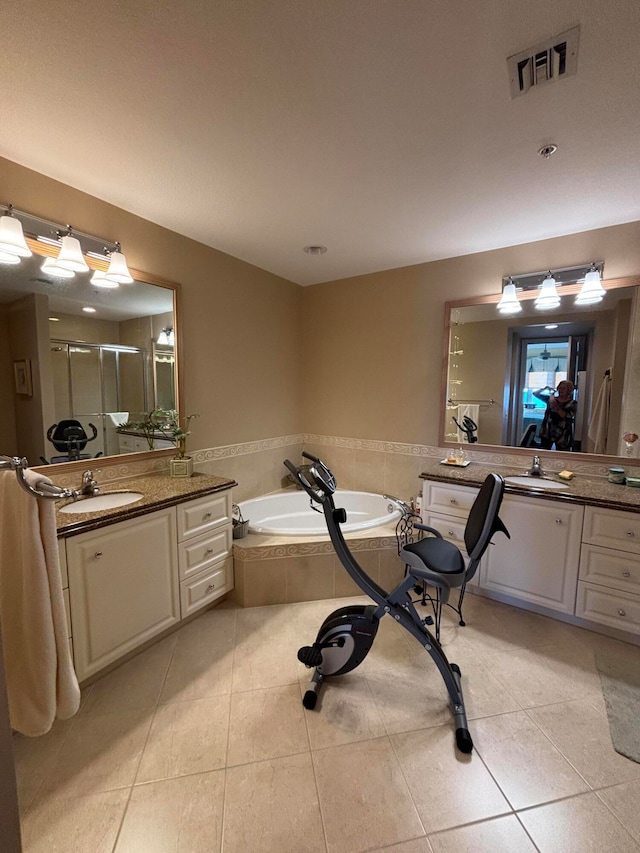 bathroom with tile patterned flooring, vanity, and shower with separate bathtub