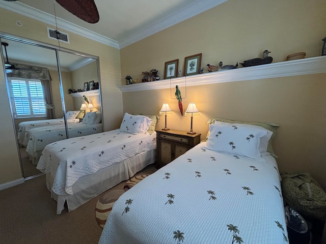 carpeted bedroom featuring a closet, crown molding, and ceiling fan