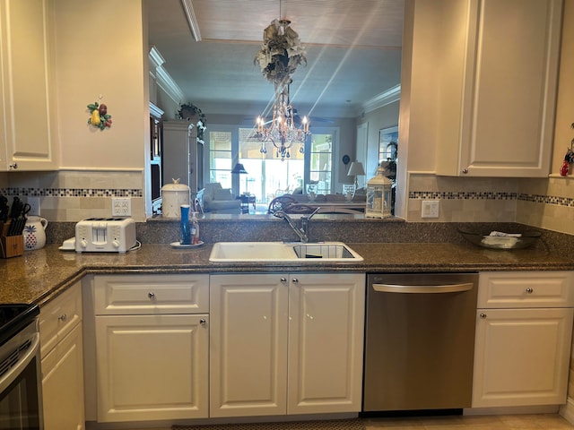 kitchen with white cabinets, backsplash, stainless steel appliances, and sink