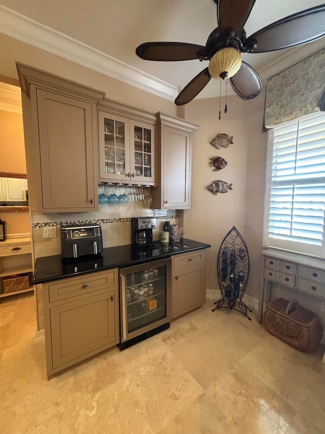 kitchen with crown molding, wine cooler, ceiling fan, dark stone countertops, and tasteful backsplash