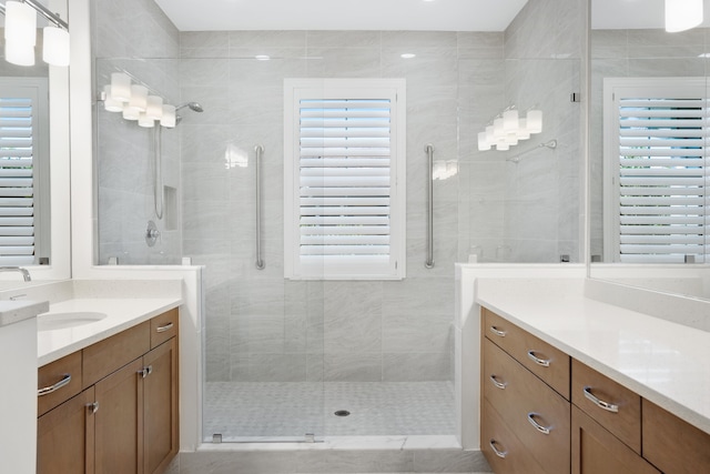 bathroom with an enclosed shower, vanity, and plenty of natural light