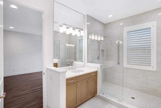 bathroom featuring vanity, wood-type flooring, and an enclosed shower