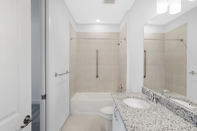 full bathroom with tile patterned floors, tiled shower / bath combo, toilet, and vanity