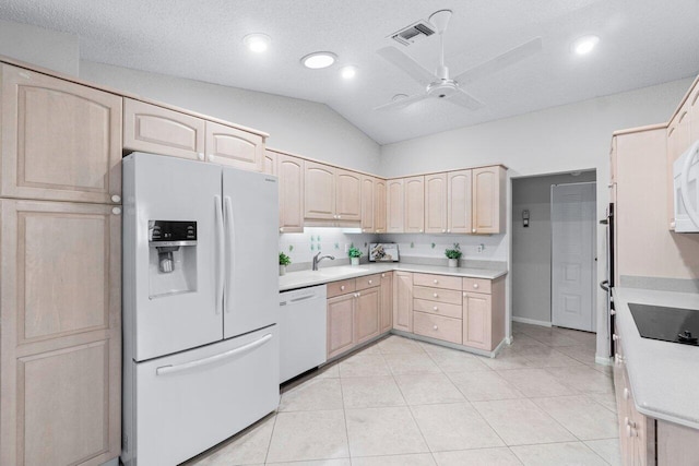 kitchen with light brown cabinetry, white appliances, ceiling fan, sink, and lofted ceiling