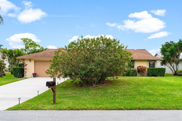 view of front of house with a garage and a front lawn