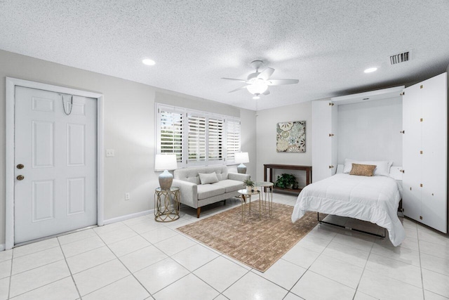 bedroom with ceiling fan, a closet, and a textured ceiling