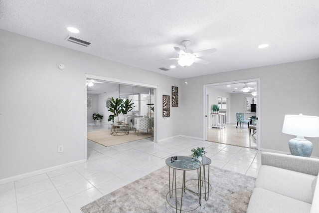 tiled living room with a textured ceiling